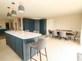 A kitchen with a dining table and chairs at Carrowmore North, Doonbeg, County Clare