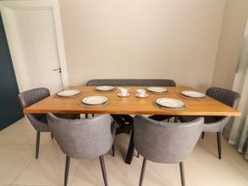 A dining room with a table set for multiple people at Carrowmore North in Doonbeg, County Clare