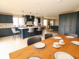 A kitchen with a dining table and stools at Carrowmore North, Doonbeg, County Clare