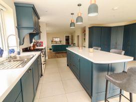 A kitchen with cabinets and an island at Carrowmore North, Doonbeg, County Clare