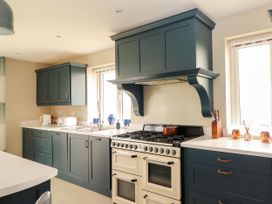 A kitchen with cabinets, oven, sink and countertop at Carrowmore North, Doonbeg, County Clare