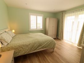A bedroom with a bed and wardrobe at Carrowmore North, Doonbeg, County Clare