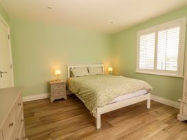 A bedroom with a bed and nightstand at Carrowmore North, Doonbeg, County Clare