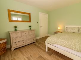 A bedroom with a bed and dresser at Carrowmore North, Doonbeg, County Clare