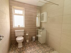 A bathroom with a toilet and sink at Carrowmore North in Doonbeg, County Clare