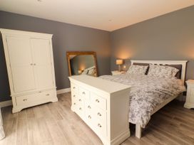 A bedroom with a bed and a wardrobe at Carrowmore North, Doonbeg, County Clare