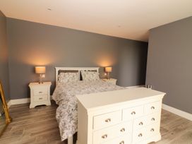 A bedroom with a bed and nightstands at Carrowmore North, Doonbeg, County Clare