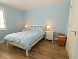 A bedroom with a bed and nightstand at Carrowmore North in Doonbeg, County Clare
