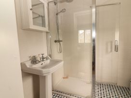 A bathroom with a shower and sink at Carrowmore North in Doonbeg, County Clare