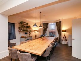 A dining room with a wooden table and chairs at Wellington Lodge in Bridlington