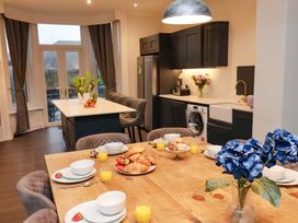 A kitchen with dining table and various food items at Wellington Lodge in Bridlington