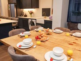 A kitchen with a dining table set for breakfast at Wellington Lodge in Bridlington