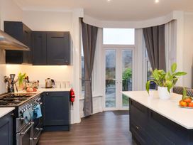 A kitchen with dark cabinets and a kitchen island at Wellington Lodge in Bridlington