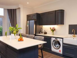 A kitchen with a washing machine and a refrigerator at Wellington Lodge in Bridlington