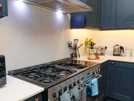 A kitchen with a stove and utensils at Wellington Lodge in Bridlington