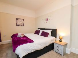 A bedroom with a bed and bedside table at Wellington Lodge in Bridlington