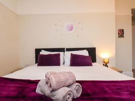 A bedroom with a bed and towels at Wellington Lodge in Bridlington