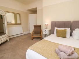 A bedroom with a bed and chair at Wellington Lodge in Bridlington