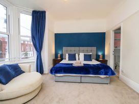 A bedroom with a bed and a sofa at Wellington Lodge in Bridlington