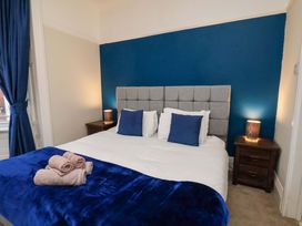 A bedroom with a bed and nightstands at Wellington Lodge in Bridlington