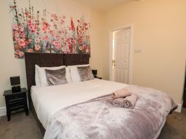 A bedroom with a bed and wall decor at Wellington Lodge in Bridlington