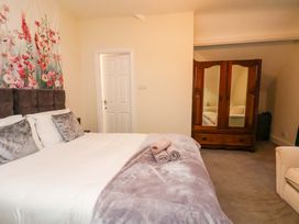 A bedroom with a bed and wardrobe at Wellington Lodge in Bridlington