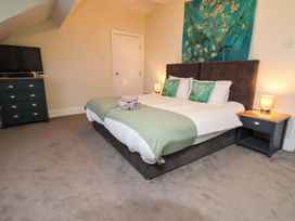 A bedroom with a bed and dresser at Wellington Lodge in Bridlington