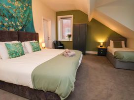 A bedroom with a bed and a single bed at Wellington Lodge in Bridlington