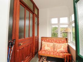 An entryway with a couch and door at Bracken Howe in Ambleside