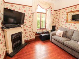 A living room with a television and a sofa at Bracken Howe in Ambleside