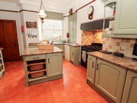 A kitchen with cabinets and appliances at Bracken Howe in Ambleside