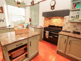 A kitchen with cabinets and stove at Bracken Howe in Ambleside