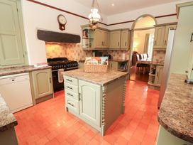A kitchen with cabinets and a central island at Bracken Howe in Ambleside