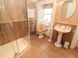 A bathroom with a shower, toilet, and sink at Bracken Howe Ambleside