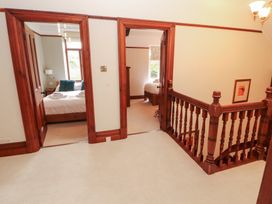 A hallway with doors leading to bedrooms at Bracken Howe in Ambleside