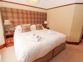 A bedroom with a bed and bedside table at Bracken Howe in Ambleside