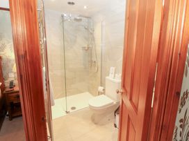 A bathroom with shower, toilet and towel rail at Bracken Howe in Ambleside