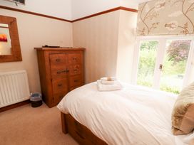 A bedroom with a bed and chest of drawers at Bracken Howe in Ambleside