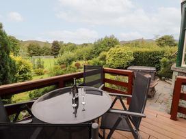 An outdoor area with a table and chairs at Bracken Howe in Ambleside