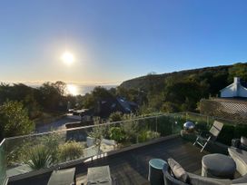 Outdoor area with seating and ocean view at Woodcroft in Pwllheli