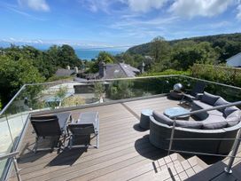 An outdoor area with seating and a view at Woodcroft in Pwllheli