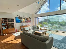 A living room with a sofa and coffee table at Woodcroft in Pwllheli