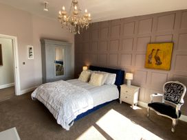 A bedroom with a bed and wardrobe at Woodcroft in Pwllheli