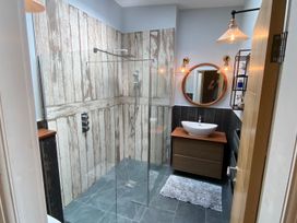 A bathroom with a shower and a sink at Woodcroft in Pwllheli