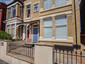 A front view of a house with a blue door at Coral Villa in Bridlington