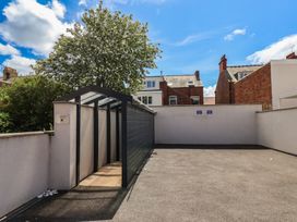 An outdoor area with a shed and tree at Coral Villa in Bridlington