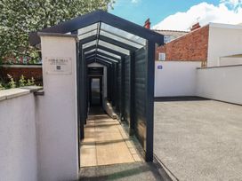An outdoor pathway with canopy leading to Coral Villa in Bridlington