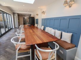 A dining area with a long table and chairs at Coral Villa in Bridlington