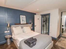 A bedroom with a bed and a shower at Coral Villa in Bridlington