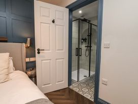 A bedroom with a door leading to a shower at Coral Villa in Bridlington